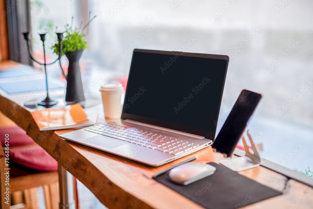 View of a laptop computer, coffee cup, comfortable working place View of a laptop computer, coffee cup, comfortable working place