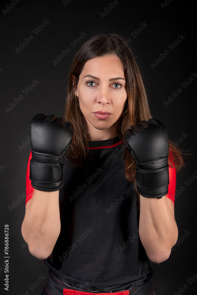 Caucasian MMA teacher posing and showing off strength, gloves