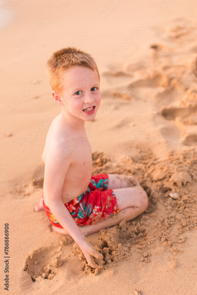 Little boy playing in the sand on beach Little boy playing in the sand on beach