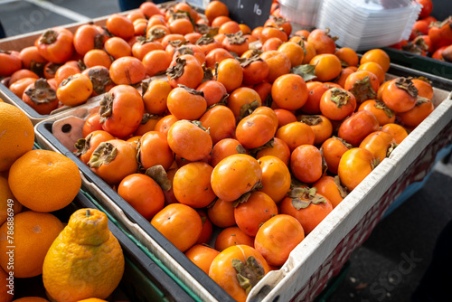 Crate of persimmons at local sustainable farmers market