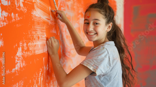 Teenage Girl Creating Colorful Mural with Paint.