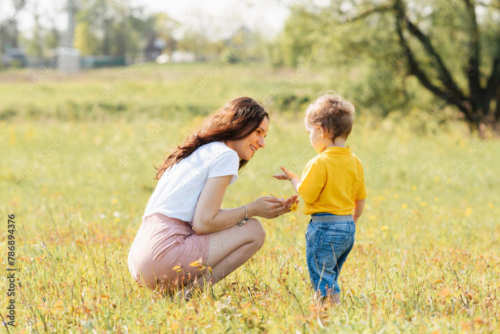 mom and son play in the field outdoors