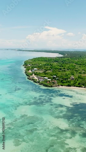 Aerial view of tropical beach with palm trees and a blue ocean. Bantayan island, Philippines.