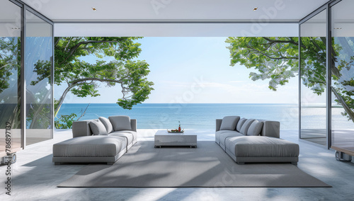 a large modern living room with grey sofas and white walls, overlooking the sea in an island. The windows show trees on one side of the wall and ocean in front. © Kien