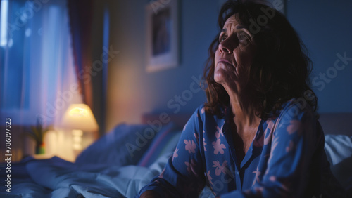 sad and depressed Asian woman sitting alone in bed at night suffering depression and anxiety feeling desperate and desperate suffering pain in mental health concept