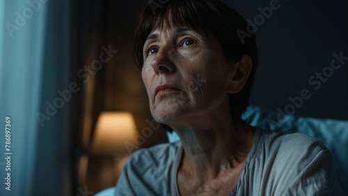 sad and depressed Asian woman sitting alone in bed at night suffering depression and anxiety feeling desperate and desperate suffering pain in mental health concept