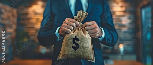 A money bag, symbolizing financial preparation, is held by the businessman. photo