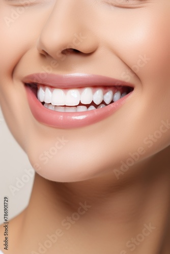 Close-up of a joyful woman brushing her teeth with a bright smile