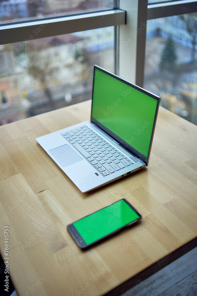 laptop and phone with green screen on single workplace table, chroma key, laptop and phone with green screen on single workplace table, chroma key,
