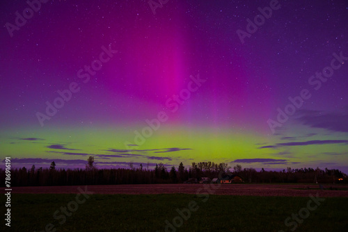 northern lights in the middle of a field on a spring night