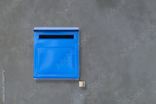 Blue color iron mailbox on square shape that installed on retro concrete wall from building for receive newspaper, letter, document and other from postman or company messenger with right copy space