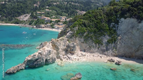 Agios Nikitas Milos Hidden Beach in Greece, with cliffs, vegetation, and rocks along the Ionian Sea shore, featuring turquoise waters and rocky islands covered in green vegetation. photo