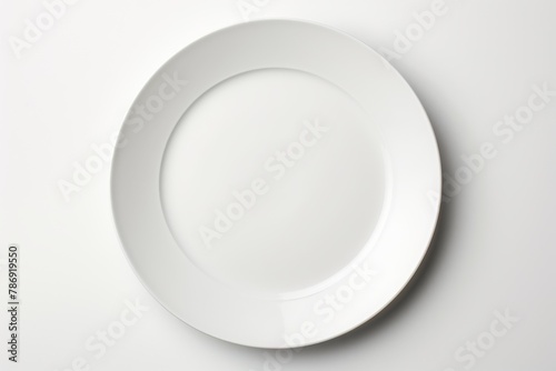 A white plate delicately balancing on a white table