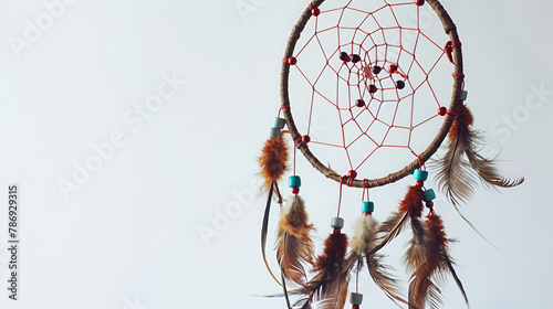 Dream catcher with feathers on a white background, Beautiful handmade dream catcher on nature background , Dream catcher with feathers threads and beads rope hanging on white background