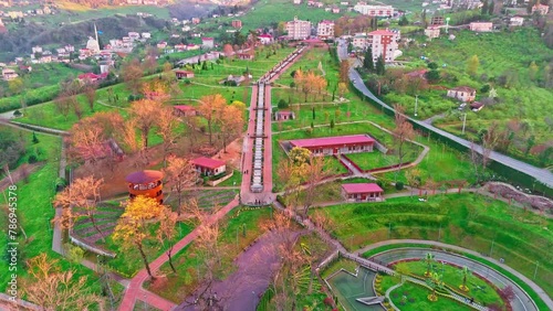 a park with a lot of trees and a lot of people photo