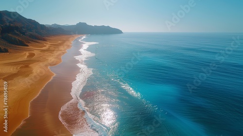 Breathtaking aerial photograph captures the pristine Teresitas Beach near Santa Cruz, showcasing the vibrant contrast between golden sands and the deep blue sea. photo