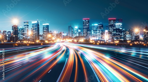 Night in the city with colorful buildings with lights from blurred car movement.