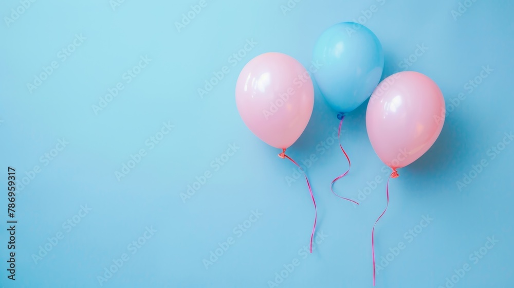 Three pastel-colored balloons floating with a baby blue background, celebrating festive moments.