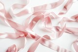 Close up of a pink ribbon on a white surface. Suitable for breast cancer awareness campaigns
