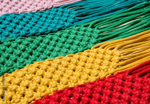 Macrame technique, a square knot of multi-colored threads. © Natalia