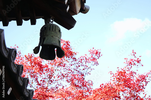 Japanese style wind chimes hanging from the eaves of the roof.