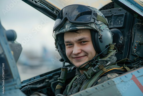A pilot in the cockpit of a military fighter plane training for war. Aviator in a helmet close up. Supply of military equipment to the allies concept © Pavel Iarunichev