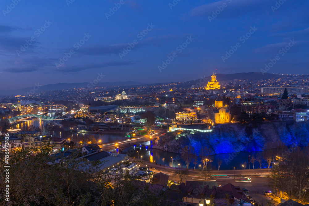 Night view of Avlabari district of Tbilisi, Georgia from Narikala fortress. Metekhi Church and Trinity Cathedral are visible.