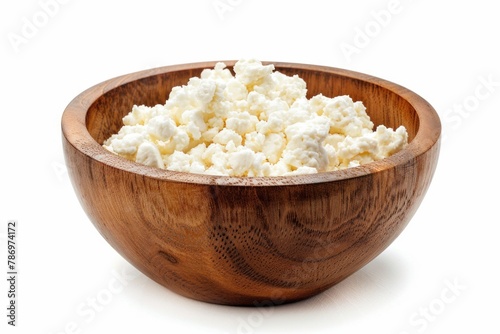 A wooden bowl of cottage cheese on a white background. Perfect for health and nutrition concepts