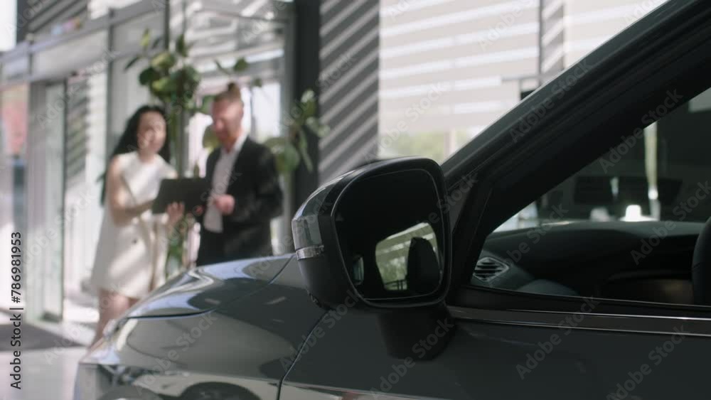 The buyer enters into an agreement to purchase a new car at the dealership. Cars in the showroom, transport rental, sale and purchase. The buyer enters into an agreement to purchase a new car at the dealership. Cars in the showroom, transport rental, sale and purchase.