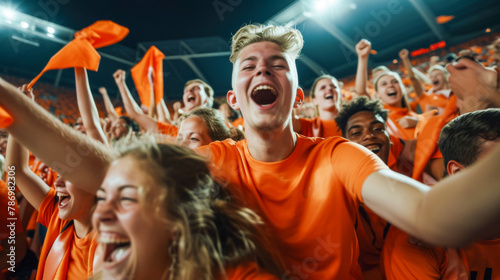 Dutch Football or soccer fans cheer and support their team on tribune in football stadium