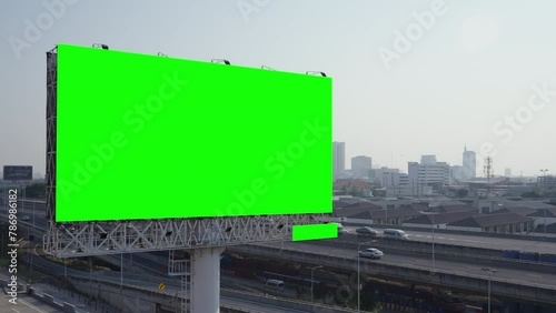A large blank billboard towers over a busy city street