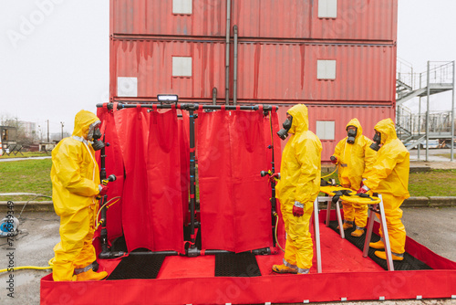 people in protective clothing and gas mask tested and work with  items during a nuclear war. danger zone. ecologi and radiation