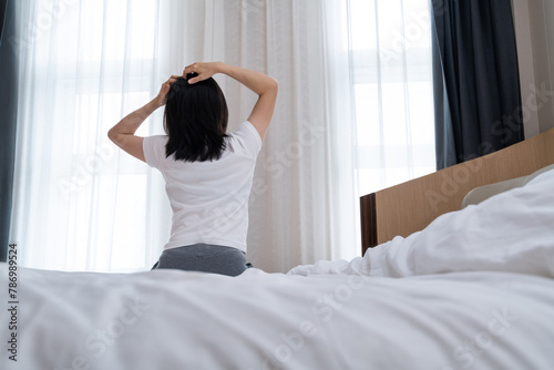 Wallpaper Mural Woman touches her head sitting by the bed Torontodigital.ca