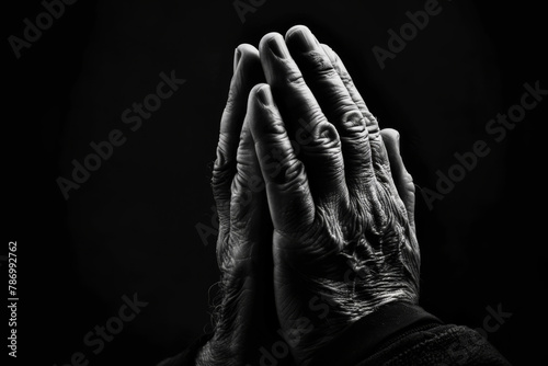 Faith, christian and praying hands in dark background with trust, hope and gratitude with prayer. Mockup space, spirituality and religion to seek guidance, wisdom or blessings for personal growth photo