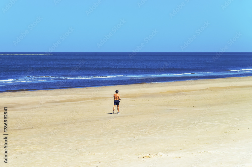 Man walking in the the beach in Montevideo, Uruguay. Man walking in the the beach in Montevideo, Uruguay.