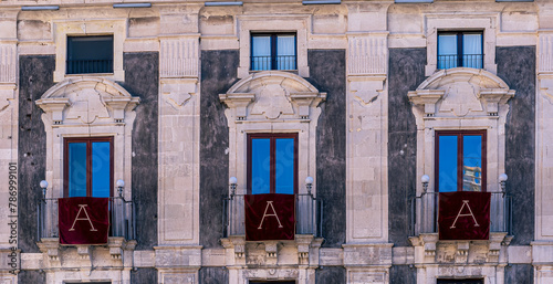 window with red banner or pennant with letter A for decotarion of old building facade photo
