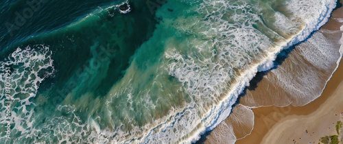 Scenic aerial view of a beach with blue ocean tide waves crashing on it. Beautiful seascape shot. Atmospheric sea coastal photography header wallpaper illustration design.