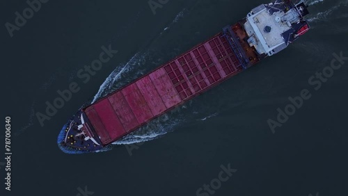 The Rix Union Cargo Vessel Leaves Behind a Frothy White Trail as it Travels Along the River in Zwijndrecht, Netherlands - Aerial Topdown Shot photo