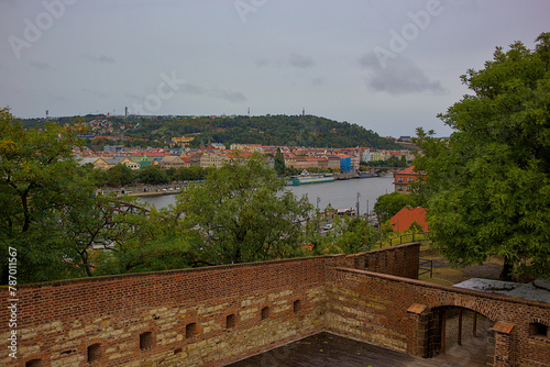 Panoramic views of the Vltava River and the city of Prague, the magical surroundings of Vysehrad. Romantic panorama of the city, red roofs, river. Exquisite architecture and vibrant life.