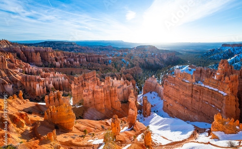 Wide angle panorama backlight shot of Bryce Canyon National Park on a cold winter morning after sunrise. Colorful orange sandstone formations Tourist attraction and sight at perfect magic moment.