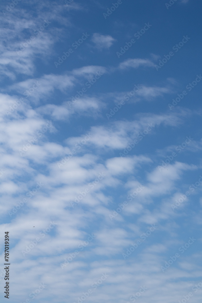 Natural pattern. Cloudy blue sky background. Calm sky and bright clouds in sunlight.
