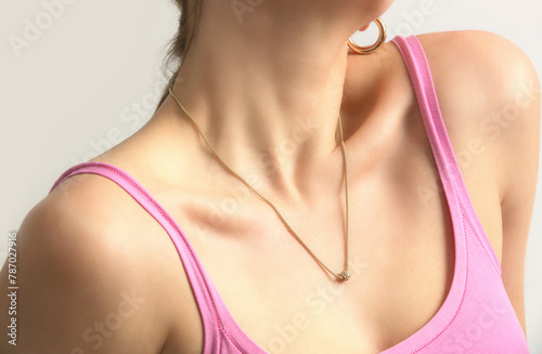 Cleavage of women with beautiful gold necklace, beautiful neck and neckline, clean skin, studio shot.