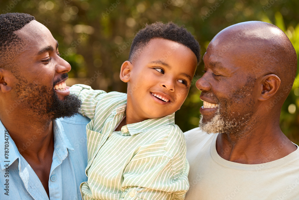 Loving Three Generation Male Family Laughing And Hugging Outdoors In Countryside Loving Three Generation Male Family Laughing And Hugging Outdoors In Countryside