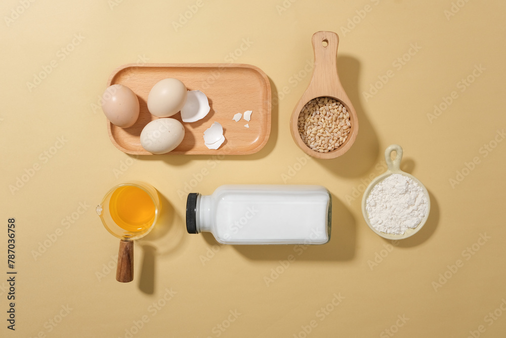 Preparation for cooking or baking with ingredients neatly arranged on pastel kitchen table from top view. Space for displaying culinary product