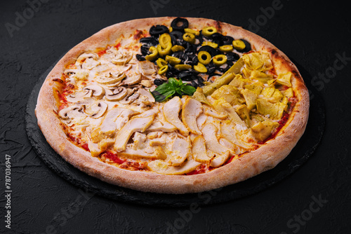 Half and half gourmet pizza on black background