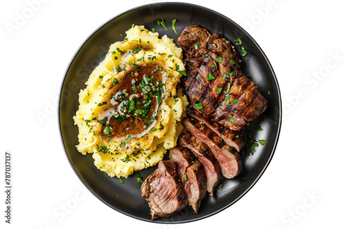 Grilled Sliced Beef Steak with Roasted Potatoes and Mashed Potato on a Dark Plate