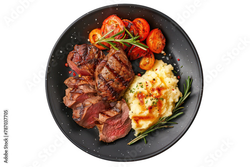 Grilled Sliced Beef Steak with Roasted Potatoes and Mashed Potato on a Dark Plate