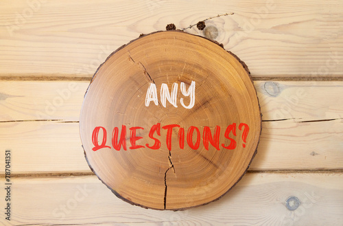 Any questions symbol. Concept words Any questions on beautiful wooden circle. Beautiful wooden wall background. Business and Any questions Q and A concept, copy space. photo