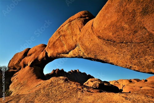 Granite rock arch in the area of Spitzkoppe - a group of bald granite peaks located between Usakos and Swakopmund in the Namib desert (Namibia) photo