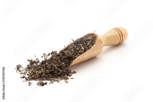 Front view of a wooden scoop filled with Organic Bhringraj (Eclipta prostrata) leaves. Isolated on a white background. photo